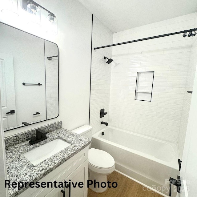 210 Carolina Drive 1000(&999), Troy, NC 27371 - bathroom featuring bathing tub / shower combination, vanity, toilet, and wood finished floors
