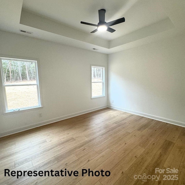 210 Carolina Drive 1000(&999), Troy, NC 27371 - spare room with a raised ceiling, wood finished floors, baseboards, and visible vents