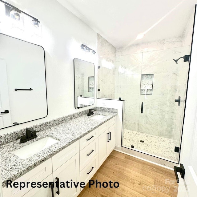 210 Carolina Drive 1000(&999), Troy, NC 27371 - full bath with a sink, a shower stall, double vanity, and wood finished floors