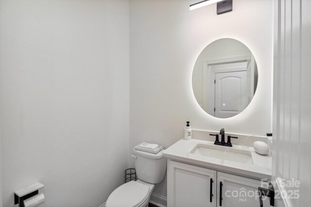 bathroom with toilet and vanity