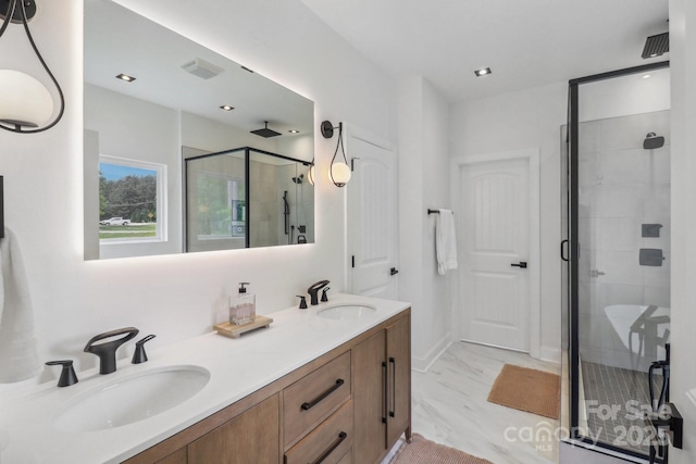 bathroom featuring a stall shower, double vanity, and marble look tiles