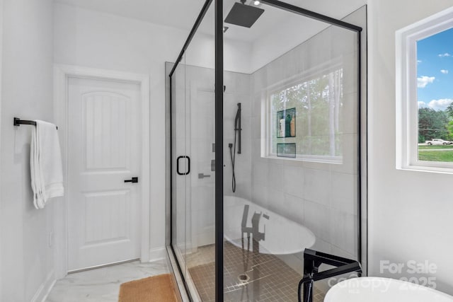 full bathroom with marble look tile flooring, a stall shower, and a soaking tub