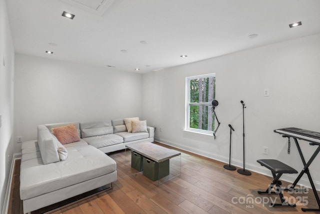 living area featuring hardwood / wood-style floors and baseboards