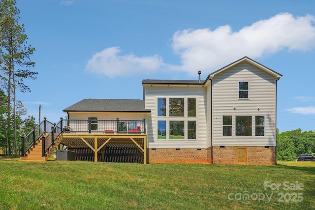 rear view of property featuring crawl space, a wooden deck, stairs, and a lawn