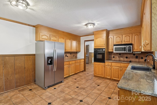 119 Legacy Ln, Harmony, NC 28634 - kitchen featuring black appliances, ornamental molding, a wainscoted wall, a textured ceiling, and backsplash
