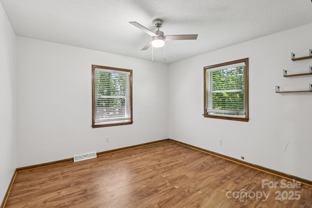 119 Legacy Ln, Harmony, NC 28634 - empty room featuring wood finished floors, a ceiling fan, and a textured ceiling