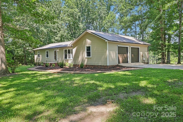 119 Legacy Ln, Harmony, NC 28634 - view of front of home with a garage, a front lawn, a metal roof, and driveway