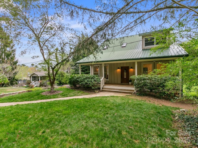 view of front of home with board and batten siding, a porch, metal roof, and a front lawn