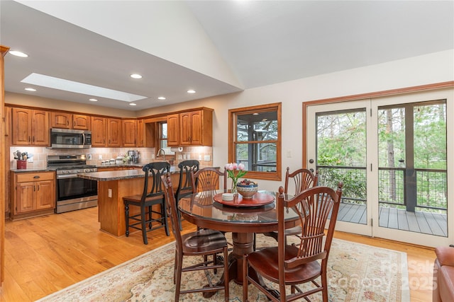 718 Lower Flat Creek Rd, Alexander, NC 28701 - dining room with a skylight, lofted ceiling, light wood finished floors, and recessed lighting