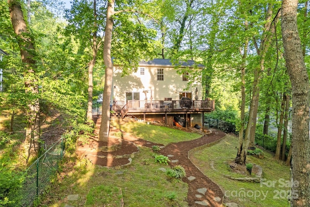rear view of property featuring a wooden deck
