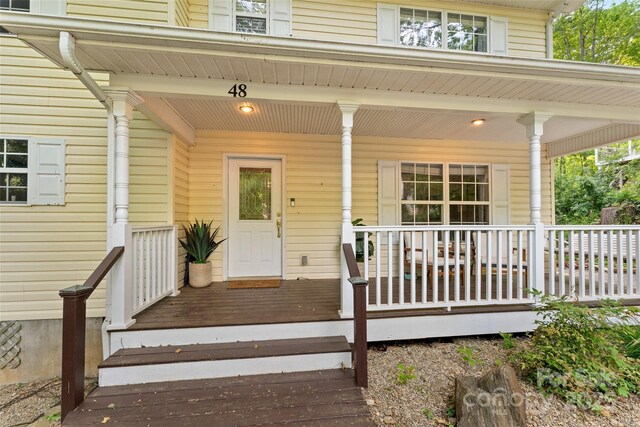 view of exterior entry with covered porch