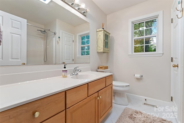 bathroom with vanity, plenty of natural light, baseboards, and visible vents
