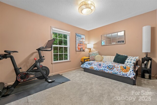 interior space with a textured ceiling and baseboards