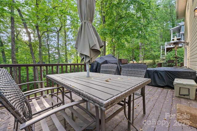 wooden deck featuring outdoor dining area