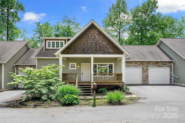 3 Teresa Way, Black Mountain, NC 28711 - craftsman-style home featuring an attached garage, a porch, driveway, a shingled roof, and stone siding
