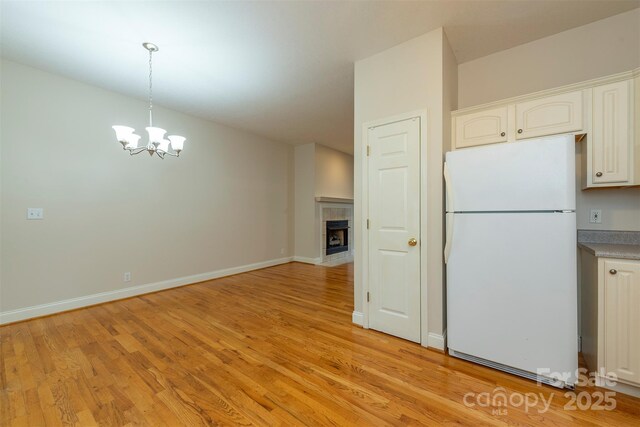 3 Teresa Way, Black Mountain, NC 28711 - kitchen with freestanding refrigerator, light wood finished floors, a chandelier, and white cabinets