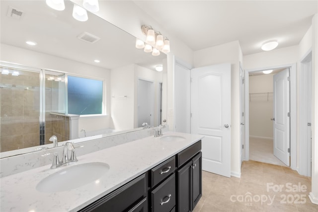 17413 Caddy Ct, Charlotte, NC 28278 - full bathroom featuring double vanity, a stall shower, tile patterned flooring, a spacious closet, and a bath