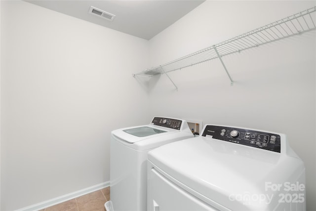 17413 Caddy Ct, Charlotte, NC 28278 - laundry room with washer and clothes dryer and light tile patterned floors