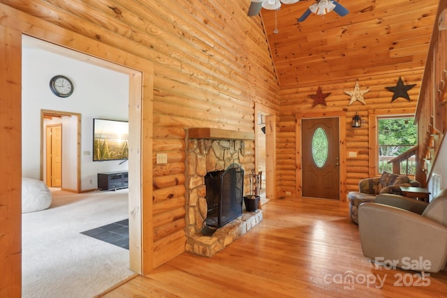 10583 Earnhardt Lake Rd, Davidson, NC 28036 - living area featuring a towering ceiling, a ceiling fan, a fireplace, and wood finished floors