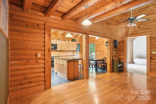 10583 Earnhardt Lake Rd, Davidson, NC 28036 - kitchen featuring wood ceiling with exposed beams, wood-type flooring, black microwave, ceiling fan, and rustic walls