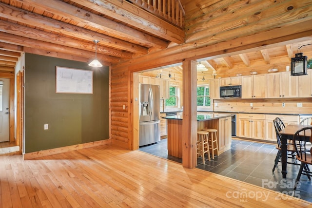 10583 Earnhardt Lake Rd, Davidson, NC 28036 - kitchen with stainless steel refrigerator with ice dispenser, black microwave, beamed ceiling, a kitchen island, and a kitchen bar