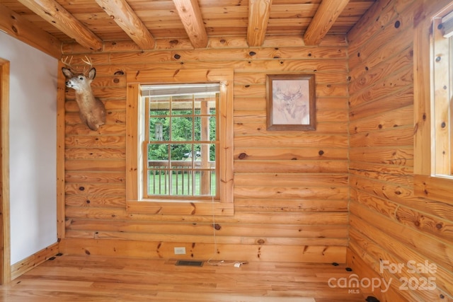 10583 Earnhardt Lake Rd, Davidson, NC 28036 - spare room featuring wood finished floors, wood ceiling with exposed beams, rustic walls, and baseboards