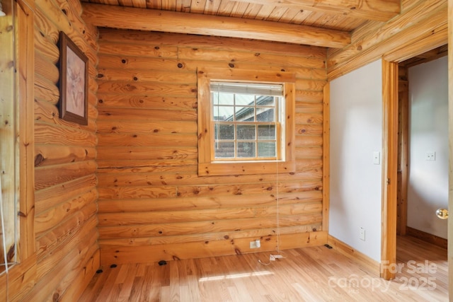 10583 Earnhardt Lake Rd, Davidson, NC 28036 - empty room featuring light wood finished floors, rustic walls, baseboards, and wood ceiling with exposed beams