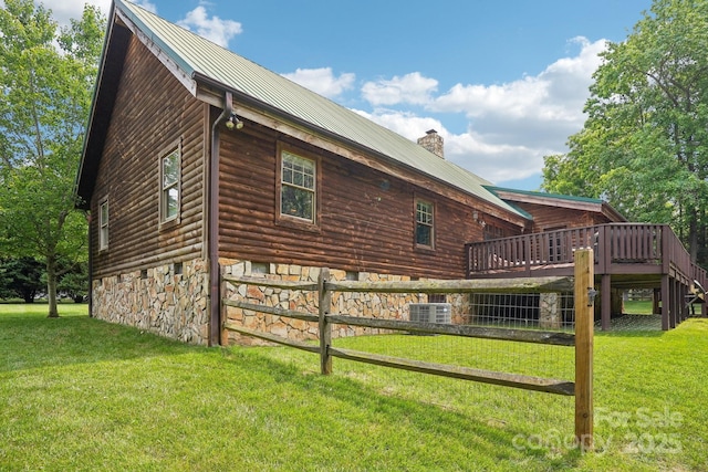 10583 Earnhardt Lake Rd, Davidson, NC 28036 - view of home's exterior featuring a chimney, metal roof, a lawn, and a wooden deck