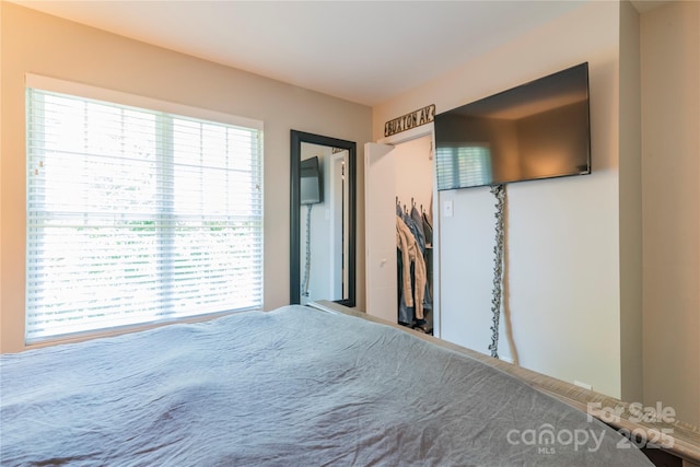 unfurnished bedroom featuring multiple windows