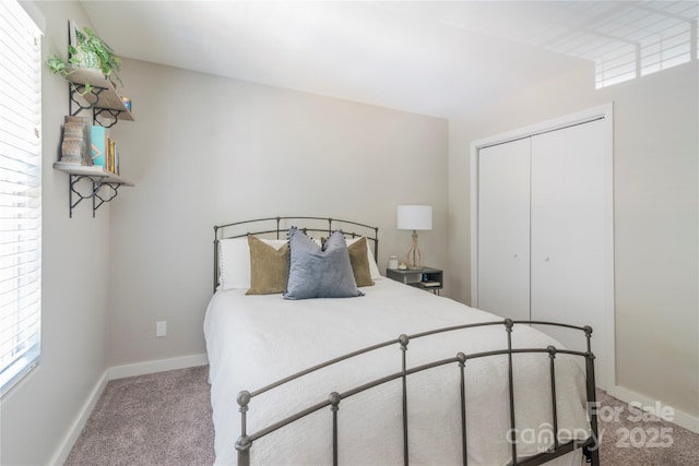 bedroom with light carpet, a closet, and baseboards
