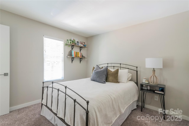 bedroom with carpet floors and baseboards