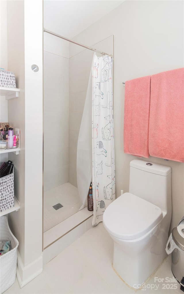 bathroom featuring toilet and a stall shower