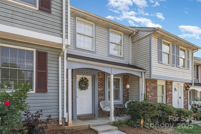 7324 Pebblestone Dr Unit E, Charlotte, NC 28212 - doorway to property with brick siding and covered porch