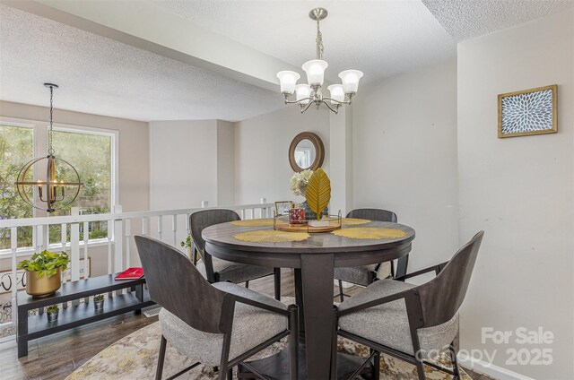 7324 Pebblestone Dr Unit E, Charlotte, NC 28212 - dining room with a chandelier, a textured ceiling, and wood finished floors