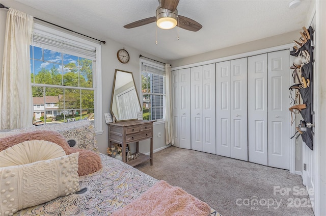 7324 Pebblestone Dr Unit E, Charlotte, NC 28212 - carpeted bedroom featuring a textured ceiling, a closet, baseboards, and a ceiling fan
