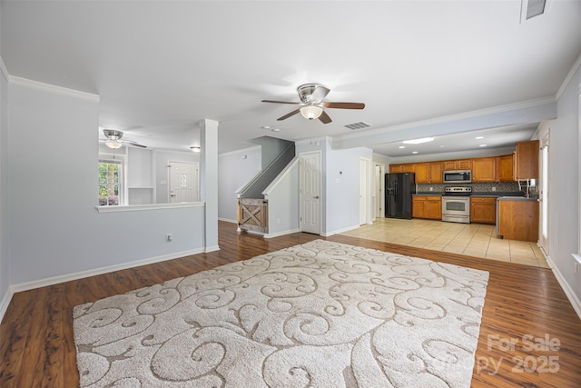 4219 Shasta Cir, Clover, SC 29710 - unfurnished living room with ceiling fan, light wood-style floors, ornamental molding, and baseboards