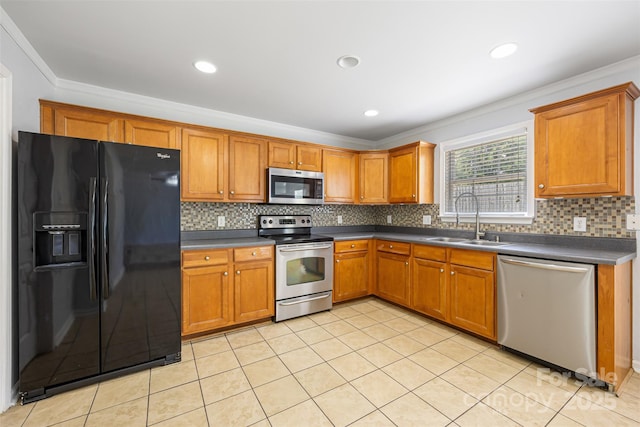 4219 Shasta Cir, Clover, SC 29710 - kitchen featuring appliances with stainless steel finishes, a sink, brown cabinetry, dark countertops, and backsplash
