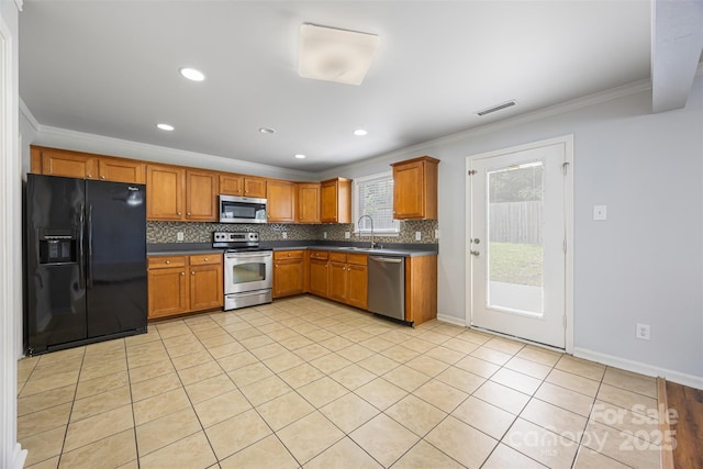 4219 Shasta Cir, Clover, SC 29710 - kitchen featuring stainless steel appliances, crown molding, a sink, tasteful backsplash, and dark countertops