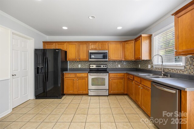 4219 Shasta Cir, Clover, SC 29710 - kitchen with appliances with stainless steel finishes, a sink, brown cabinetry, ornamental molding, and recessed lighting
