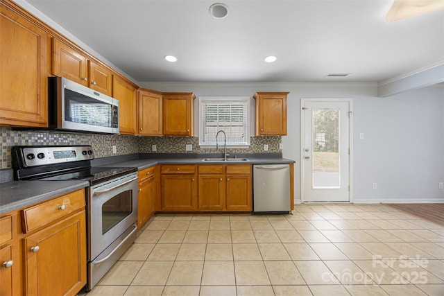 4219 Shasta Cir, Clover, SC 29710 - kitchen with appliances with stainless steel finishes, a sink, crown molding, backsplash, and dark countertops