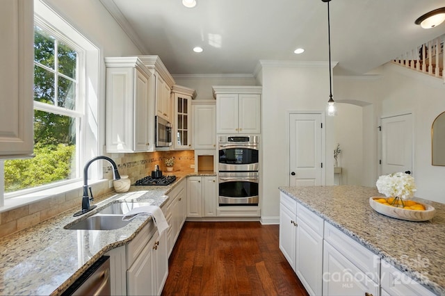 404 Brookridge Dr, Mount Holly, NC 28120 - kitchen with a sink, appliances with stainless steel finishes, plenty of natural light, light stone counters, and ornamental molding