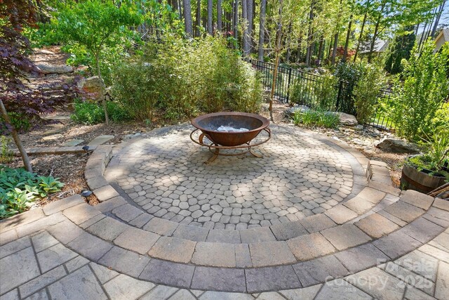 404 Brookridge Dr, Mount Holly, NC 28120 - view of patio featuring an outdoor fire pit and fence