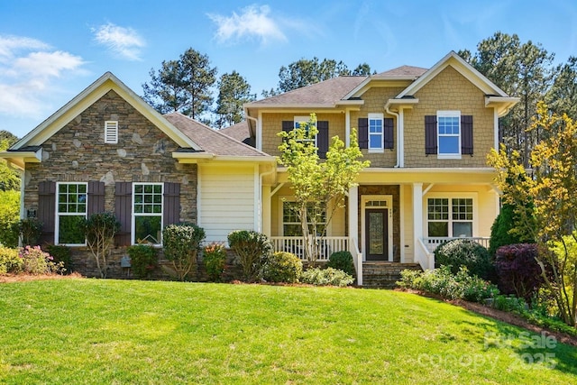 404 Brookridge Dr, Mount Holly, NC 28120 - craftsman-style home with a front yard, a porch, and stone siding