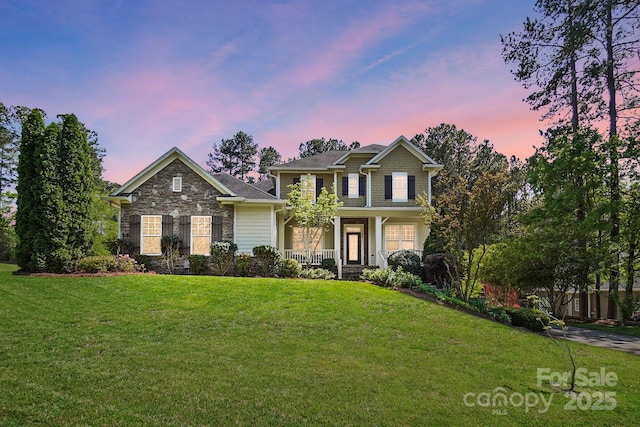 404 Brookridge Dr, Mount Holly, NC 28120 - view of front of property with covered porch, a front lawn, and stone siding