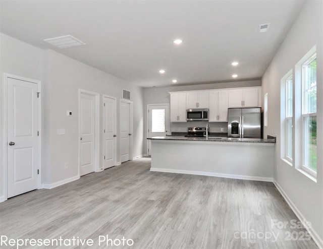558 Ridge Ave, Mooresville, NC 28115 - kitchen featuring white cabinetry, visible vents, light wood-type flooring, and appliances with stainless steel finishes