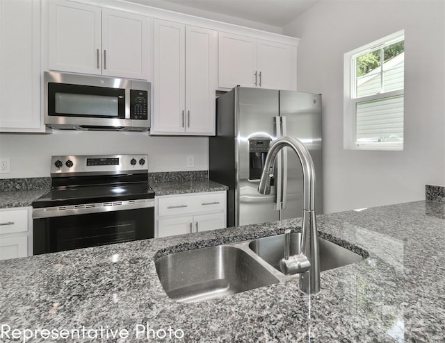 558 Ridge Ave, Mooresville, NC 28115 - kitchen with a sink, white cabinetry, dark stone countertops, and stainless steel appliances