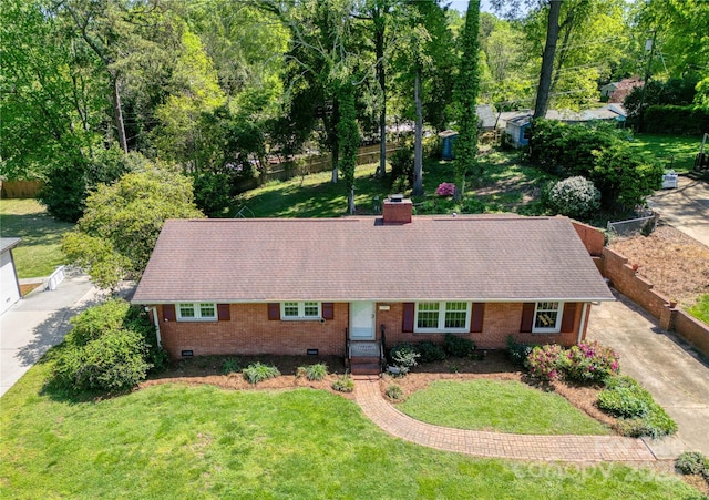 ranch-style home with crawl space, a chimney, a front yard, and brick siding