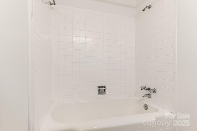 bathroom featuring a tub and walk in shower