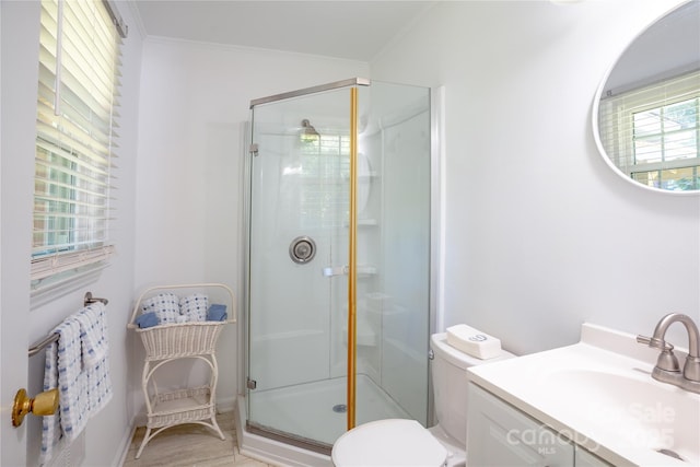 full bath with a shower stall, vanity, ornamental molding, and toilet