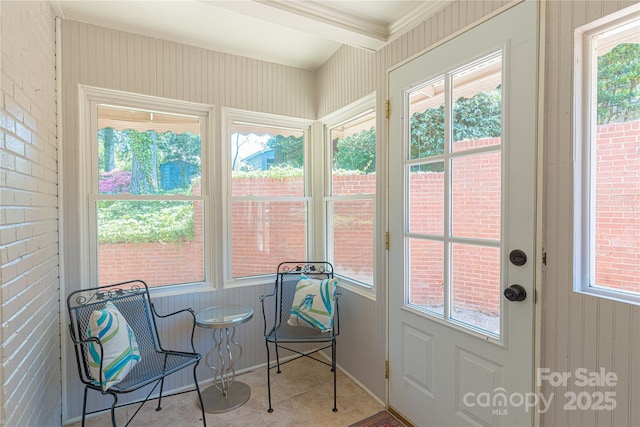 sunroom / solarium with brick wall and beamed ceiling